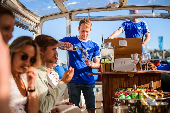 Amsterdam: Canal Booze Cruise with Unlimited Drinks Option - Boat comfort in rain and night: why covered seating matters