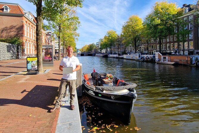 Amsterdam Canal Tour by Open Boat – 90 min Small Group Experience - What You See From The Amstel: Dancing Houses, Leaning Buildings, And The Munt Tower