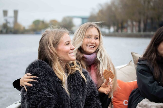 Amsterdam: Luxury Saloon Boat Cruise with Cocktails & Waffle - Amsterdam Central Station, Weepers’ Tower, and the stories stuck to stone