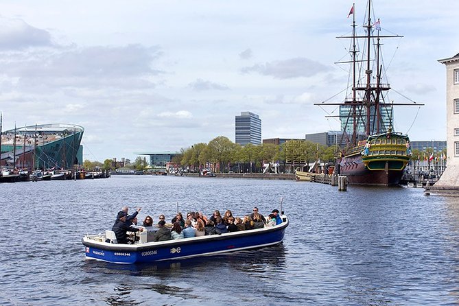 Amsterdam Open Boat Sightseeing Canal Cruise - Open boat comfort: rain gear and glare tactics