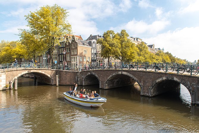 Amsterdam Open Boat Tour with Local Guide - Captain-led narration: personal, interactive, no earbud crutch
