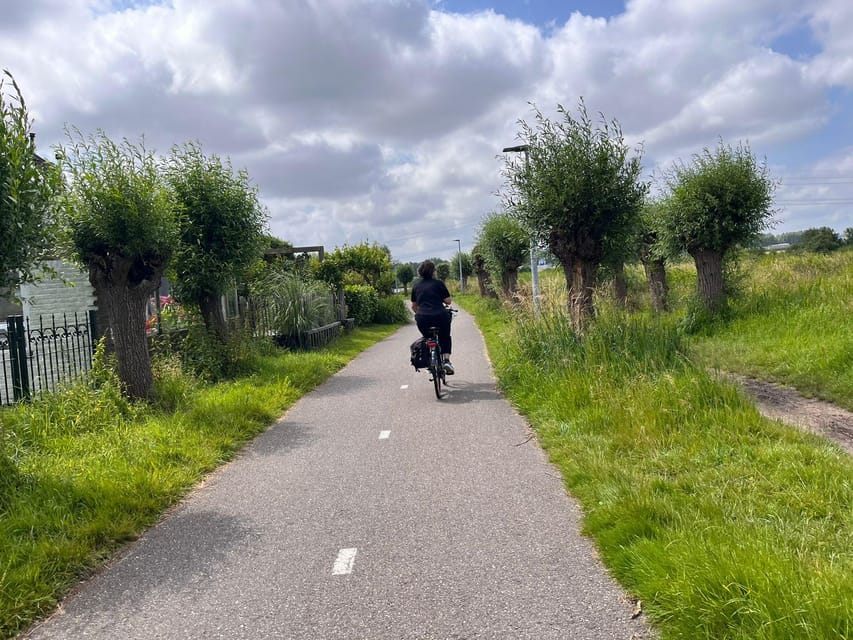 Amsterdam: Rainbow Rural Bike Tour With Local Gay Guide - The centuries-old windmill stop: waterworks you can see