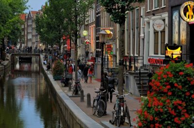 Amsterdam Red Light District tour with a local guide - Zeedijk Street: Sailors, Prostitution Beginnings, and Why the Location Matters