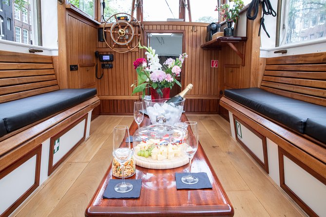 Amsterdam Small-Group Canal Cruise With Dutch Snacks and Drink - Westerkerk, bridges, and the Anne Frank House area—landmarks you can actually place