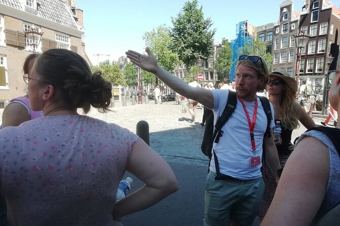 Amsterdam Walking Tour with a local comedian as guide - Kalverstraat Crossing at Spui: Shopping Stories with a Local Twist