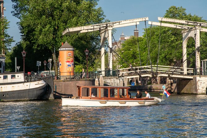 Private Boat Tour Amsterdam - 90 Min incl. welcome drink on historic saloon boat - What You’ll See: Amsterdam’s Canals From a Slow, Water-Level Perspective